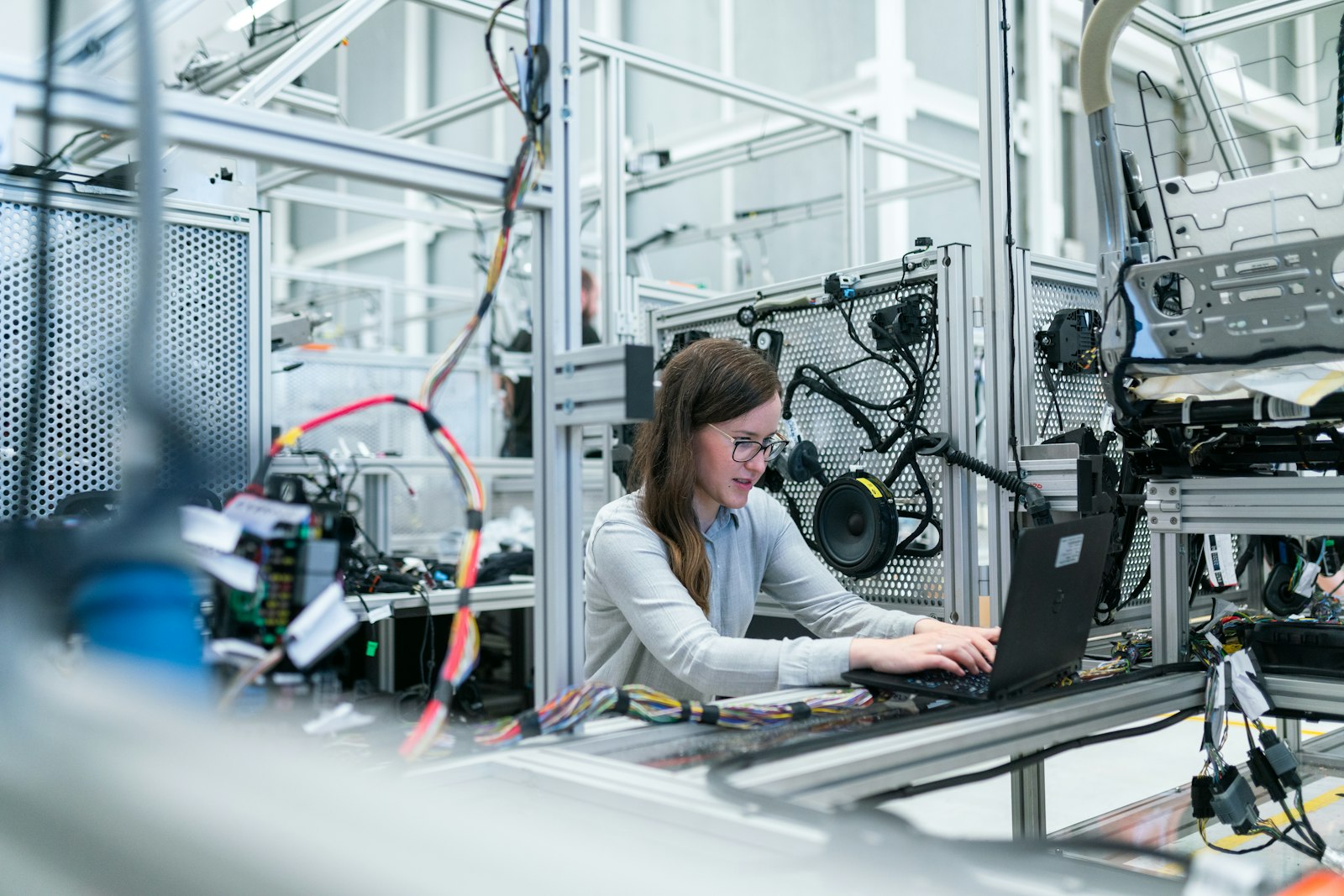 Engineers reviewing work on a tablet at a manufacturing plant. Photo: Unsplash.