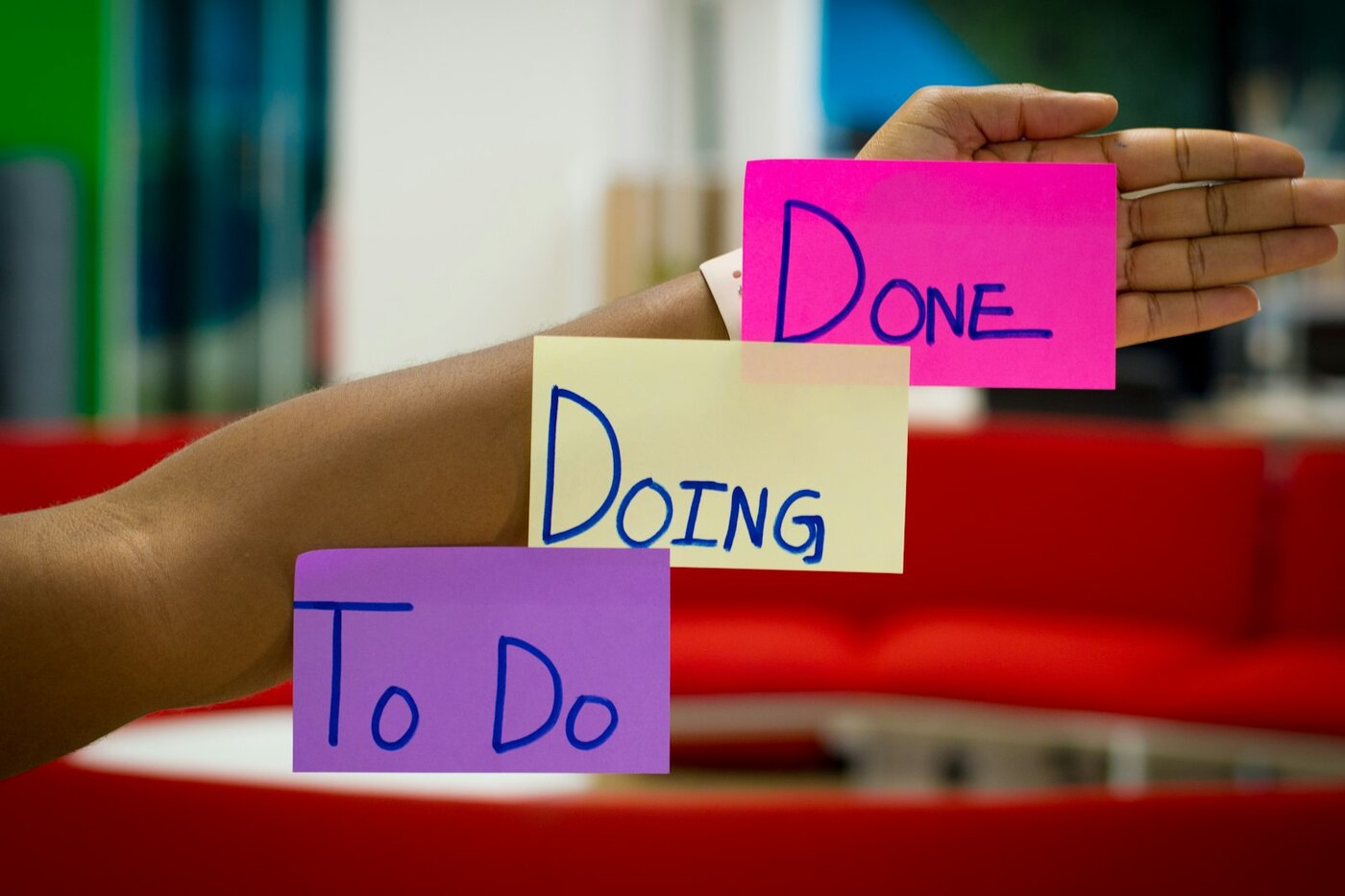 Sticky notes labeled To Do, Doing, and Done on a forearm—ECO workflow stages from proposal through implementation. Photo: Unsplash.