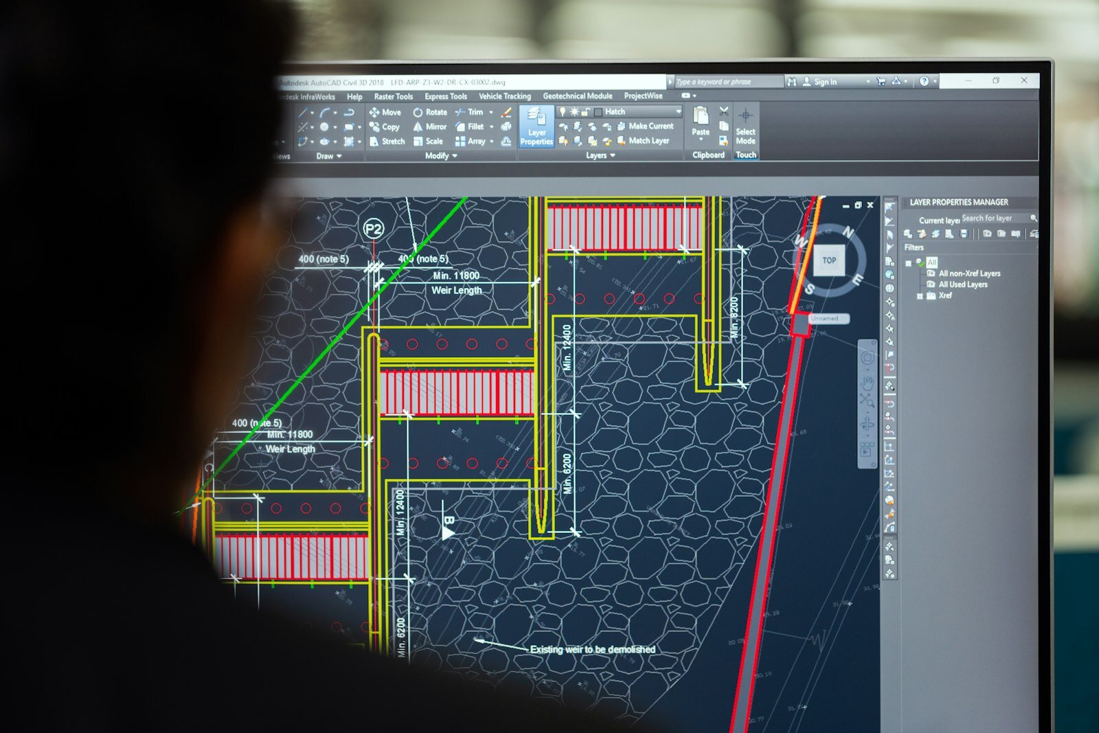 Engineer reviewing technical designs on a dual-monitor workstation—the CAD-side moment SimScale’s Onshape agent targets for early CFD and FEA feedback. Photo: Unsplash.