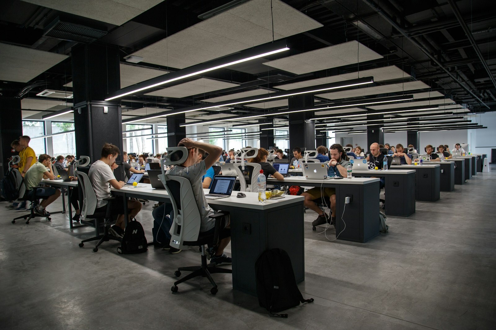 Open-plan office of frontline knowledge workers—scale of users an ERP cutover must carry without fragmenting process. Photo: Unsplash.