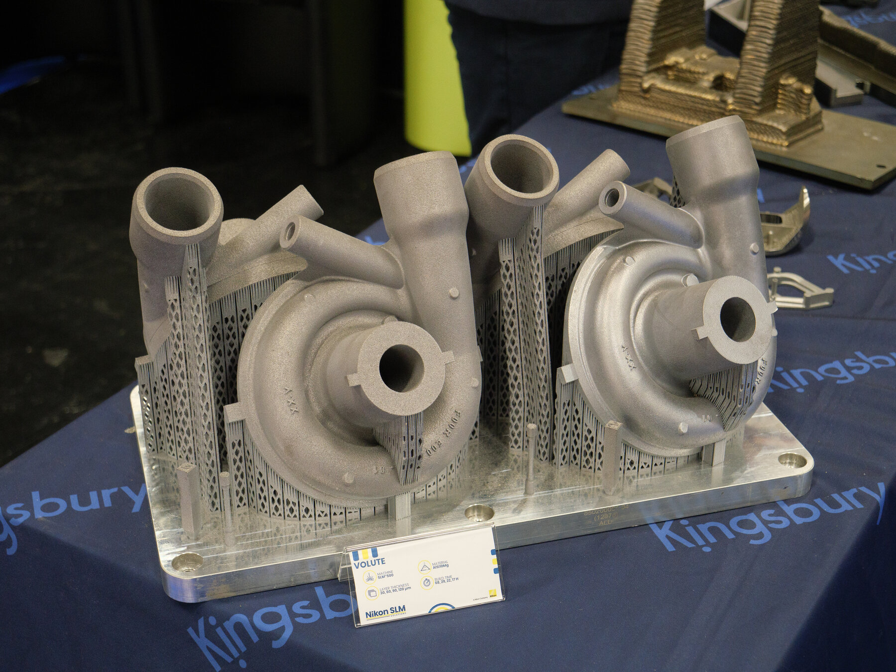 Selective laser melting metal parts on display—laser powder-bed fusion hardware of the class used for aerospace copper and nickel alloys. Photo: Wikimedia Commons.