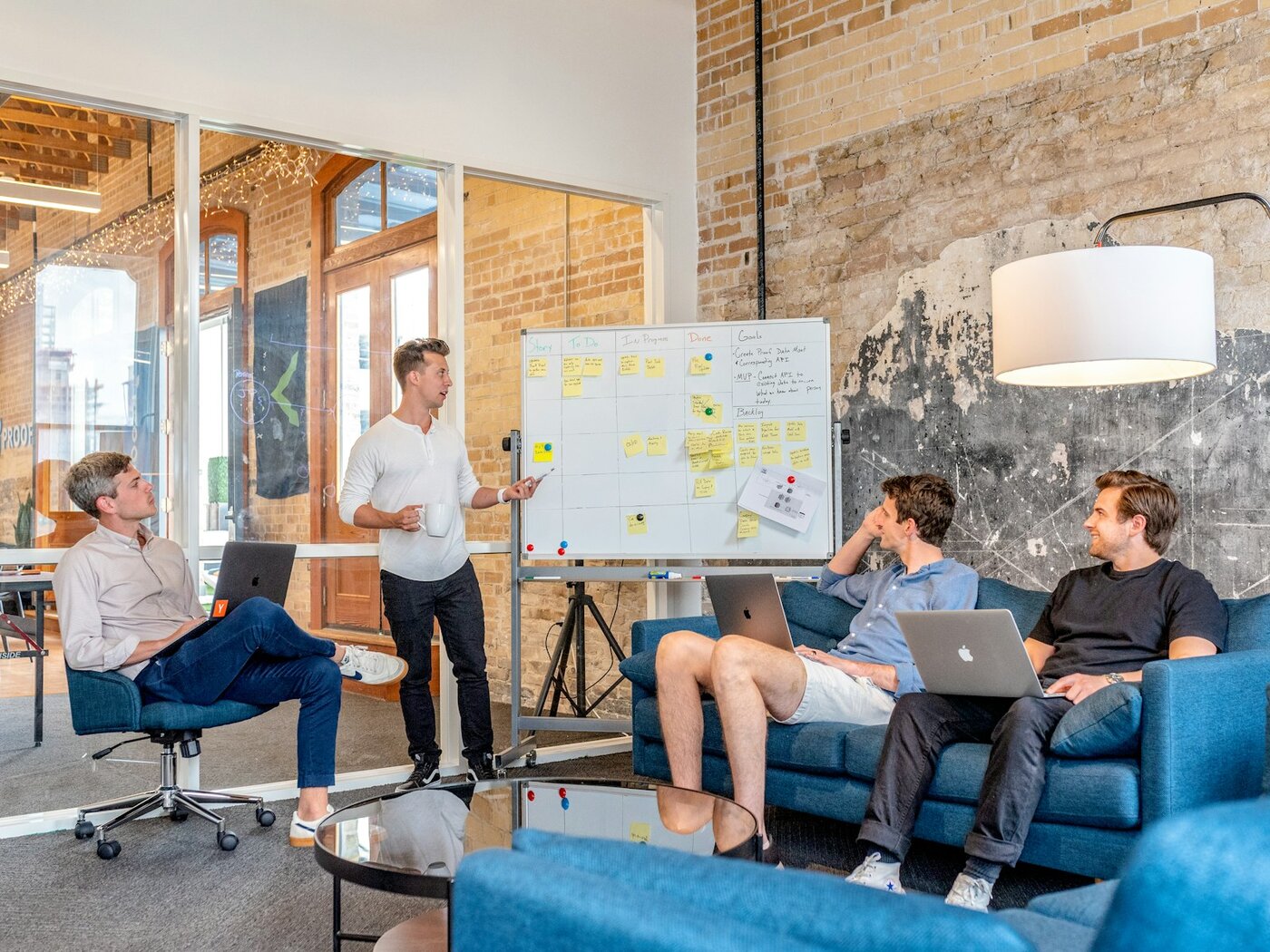 Engineering team collaborating at a whiteboard in a modern industrial office