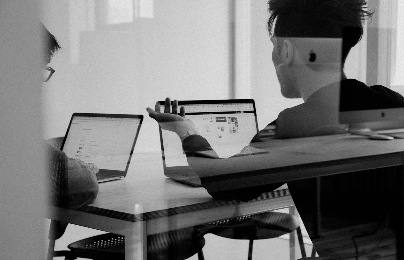 Cross-functional industrial team collaborating—the commercial and service workflows Siemens wants to feed with Teamcenter product truth. Photo: Unsplash.