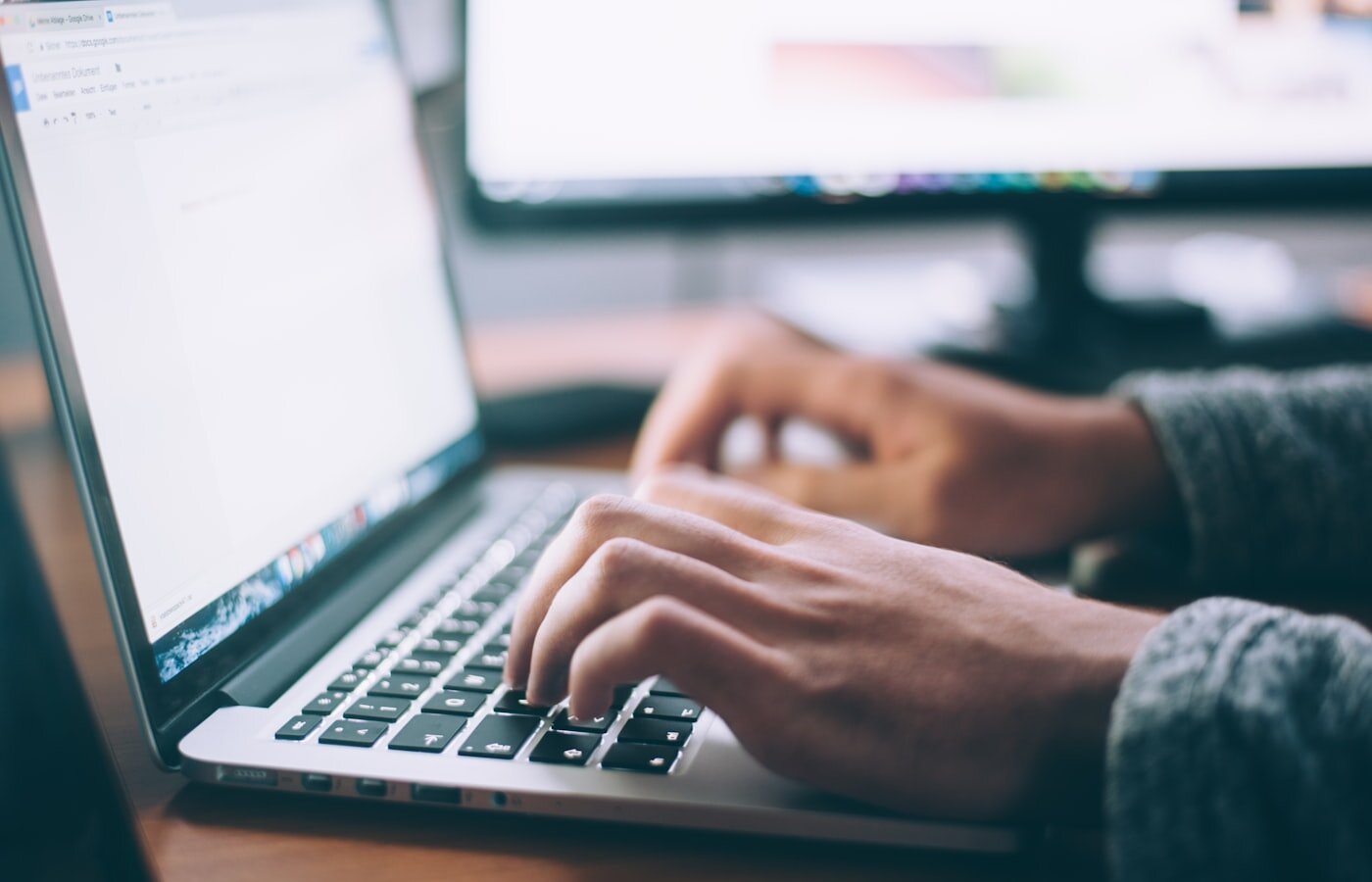 Laptop on a desk for commercial and service work—where Agentforce now answers with Teamcenter-backed product data. Photo: Unsplash.