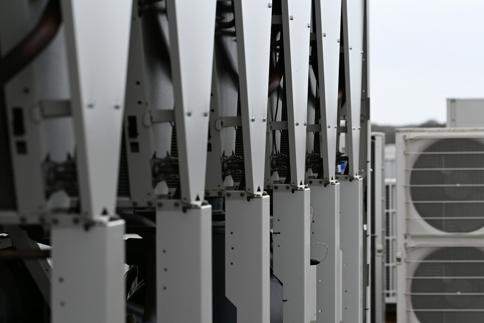 Industrial chiller unit on a rooftop during a pre-season checklist—HVAC programs couple plant CapEx to product launches. Photo: Carl Wragg / Unsplash.