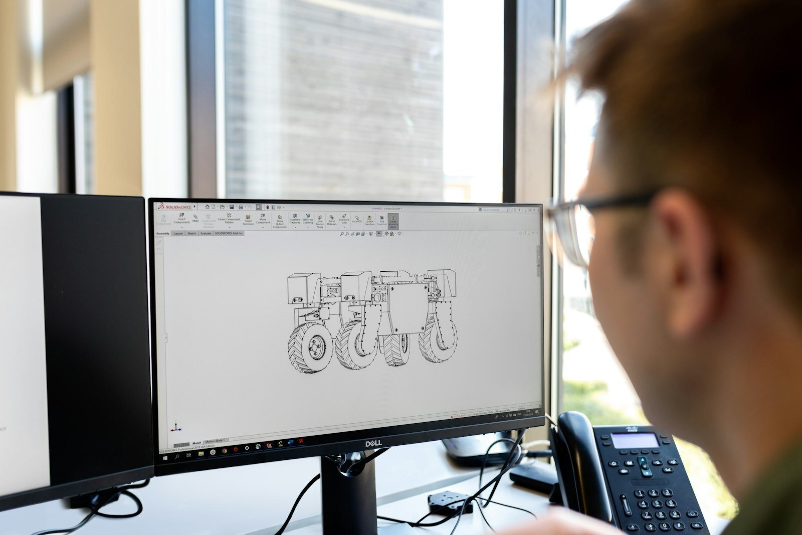 Mechanical engineer reviewing a design on a computer workstation