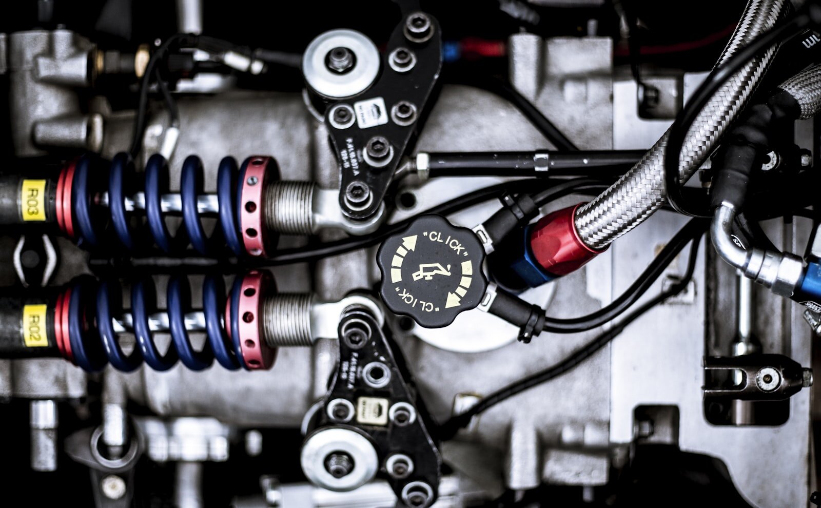 Precision mechanical assembly with coil springs, fittings, and linkages