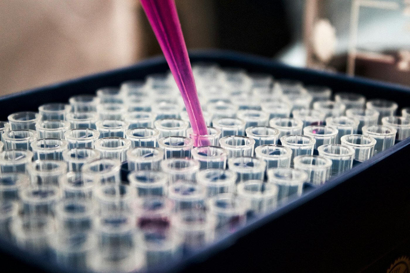 Pipette dispensing sample into a lab vial rack—precision testing behind connected nonconformance and CAPA records. Photo: Unsplash.