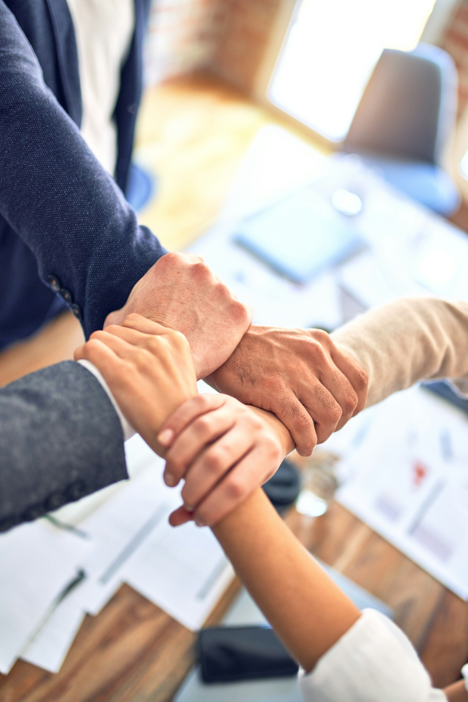 Cross-functional team collaborating around laptops—the human Change Control Board the Air Force PLM RFI still depends on. Photo: Unsplash.