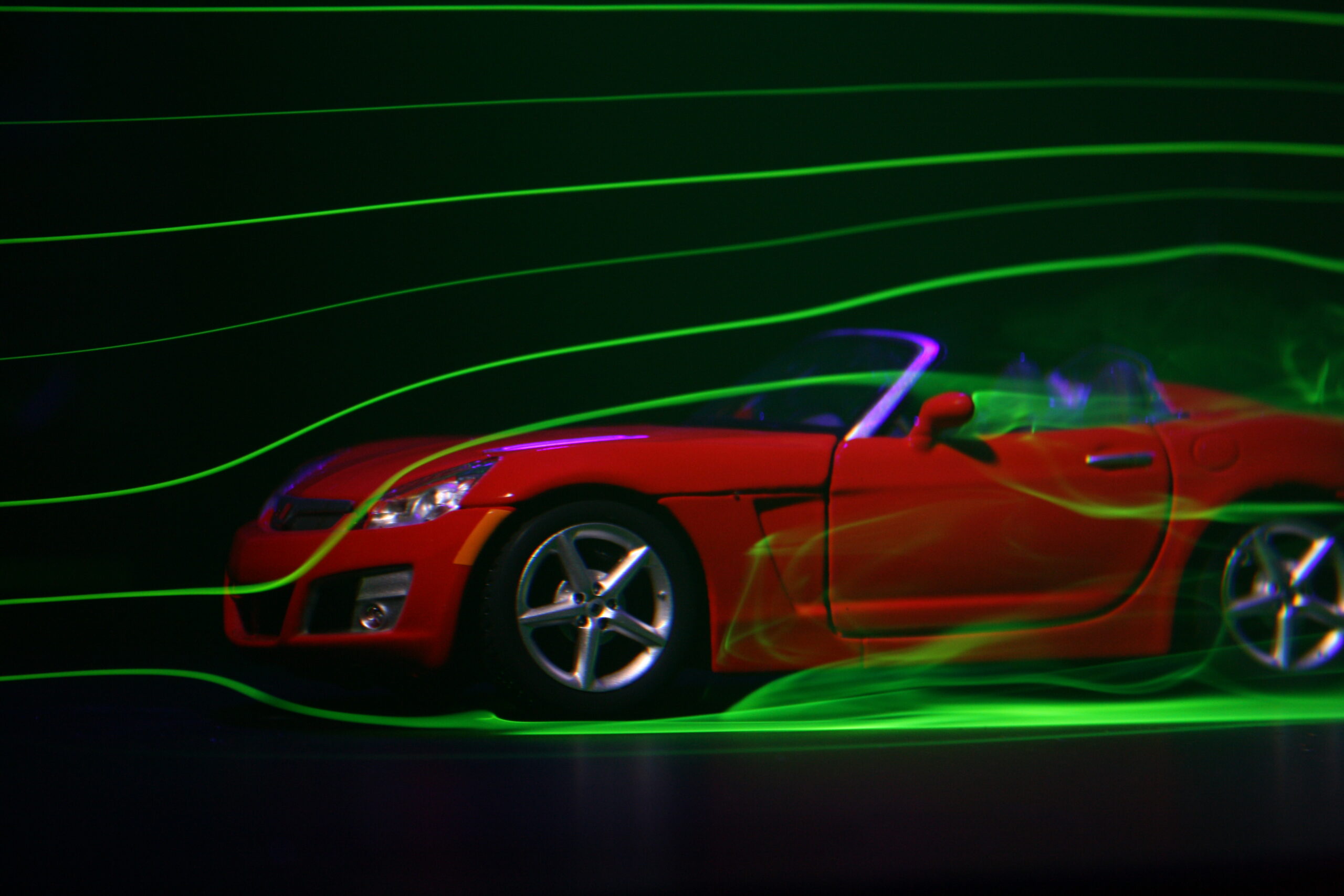 Scale model car in a wind tunnel with smoke flow visualization