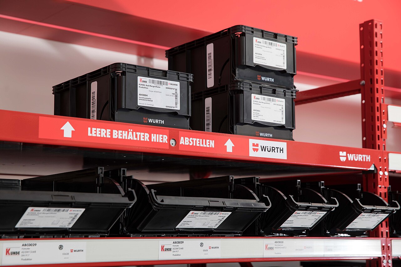 RFID Kanban bins for automated C-parts replenishment on an industrial service rack.