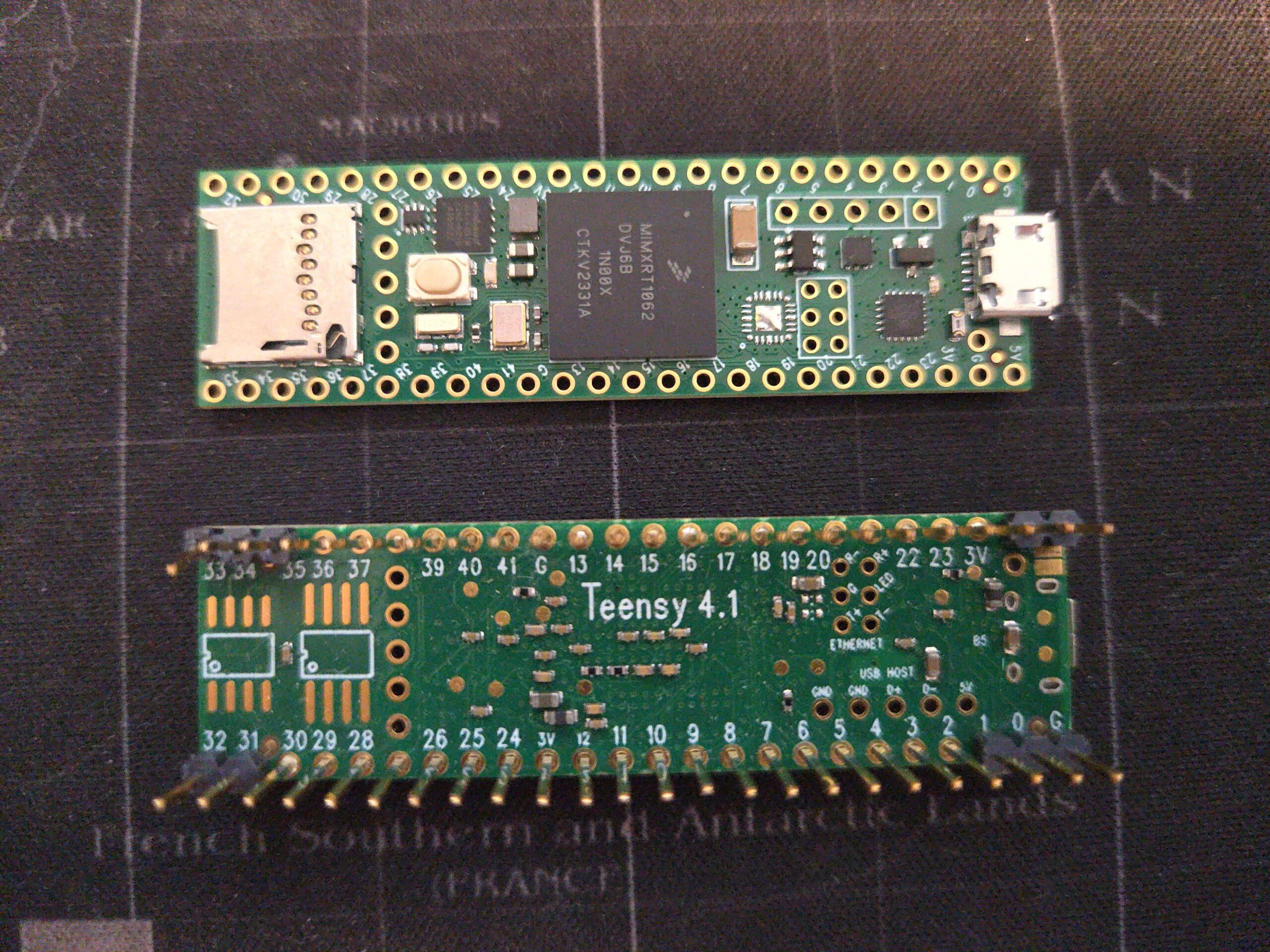 Two Teensy 4.1 microcontroller boards, top and bottom, with the NXP i.MX RT1062 chip visible. Photo: SpencerWF, CC0, via Wikimedia Commons.