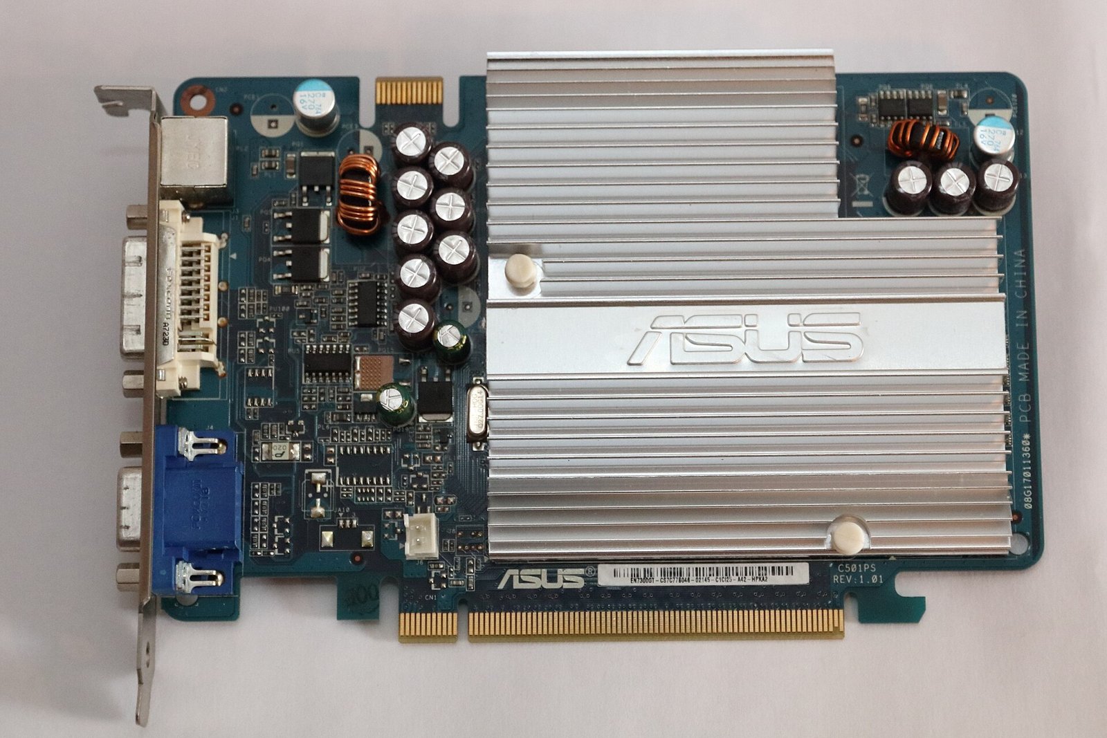 A passively cooled Asus graphics card with a large aluminum heatsink, photographed from above on a white background. Photo: MKFI, public domain, via Wikimedia Commons.