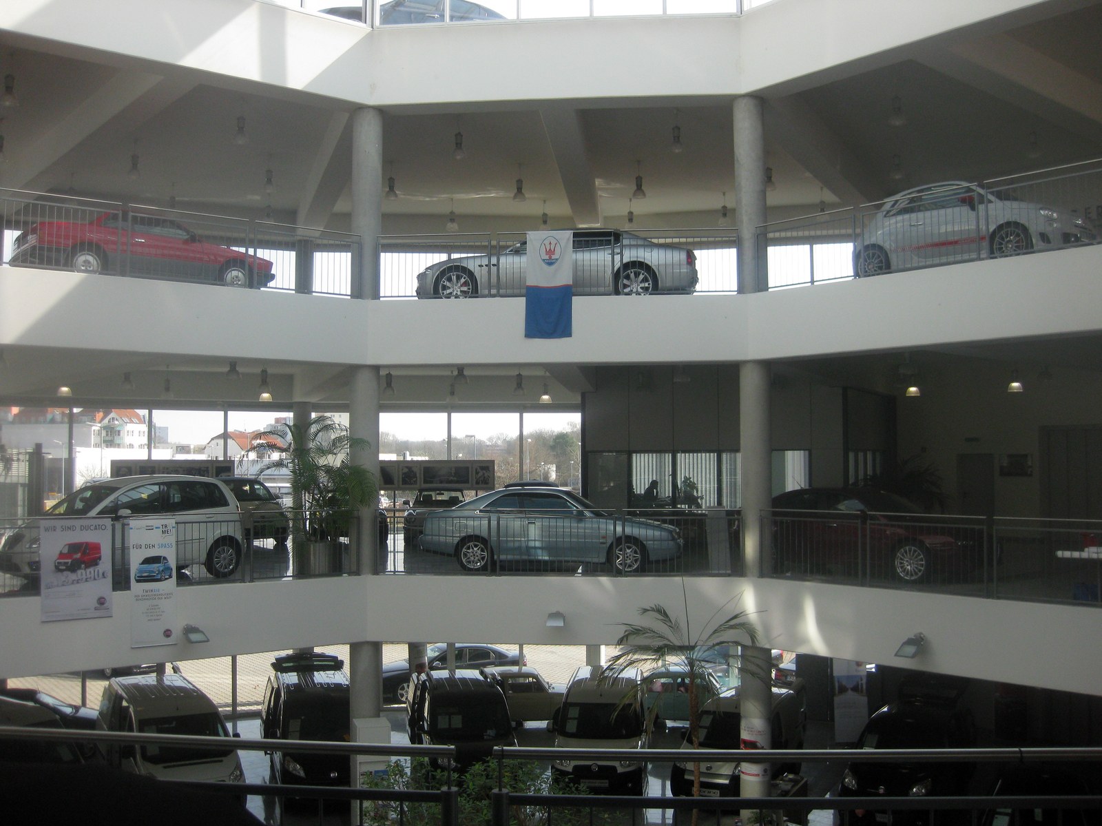 Automobile dealership showroom floor—dealer channel where complex configure-price-quote still depends on product experts translating customer needs. Photo: ChristosV / Wikimedia Commons.
