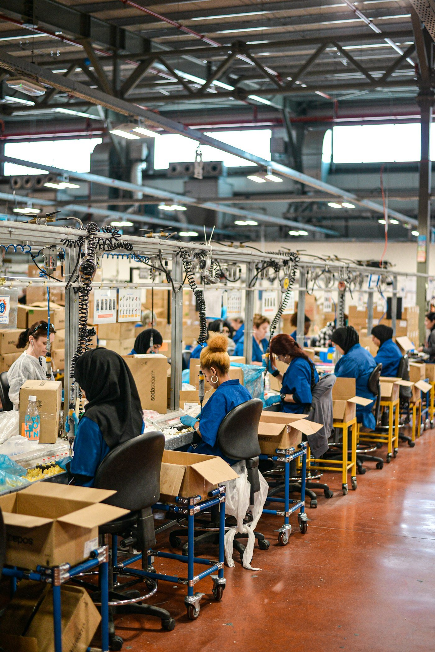 Operators on a factory assembly line—where Shop Floor Kiosk 2.0 has to be the only screen that matters. Photo: Remy Gieling / Unsplash.