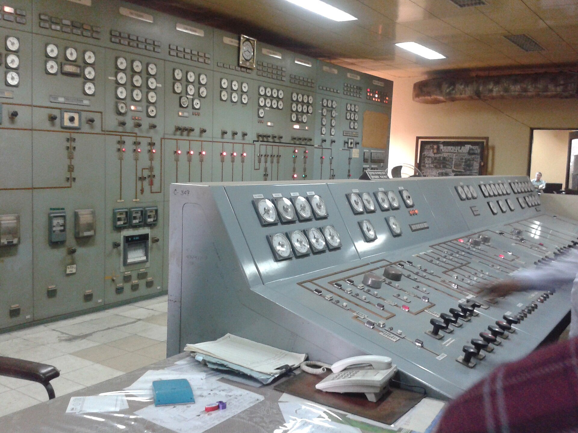 Vintage power-plant control room packed with gauges and consoles—the metaphor for CapEx oversight that still runs on lagging indicators. Photo: Magnetic Rahim / Wikimedia Commons.