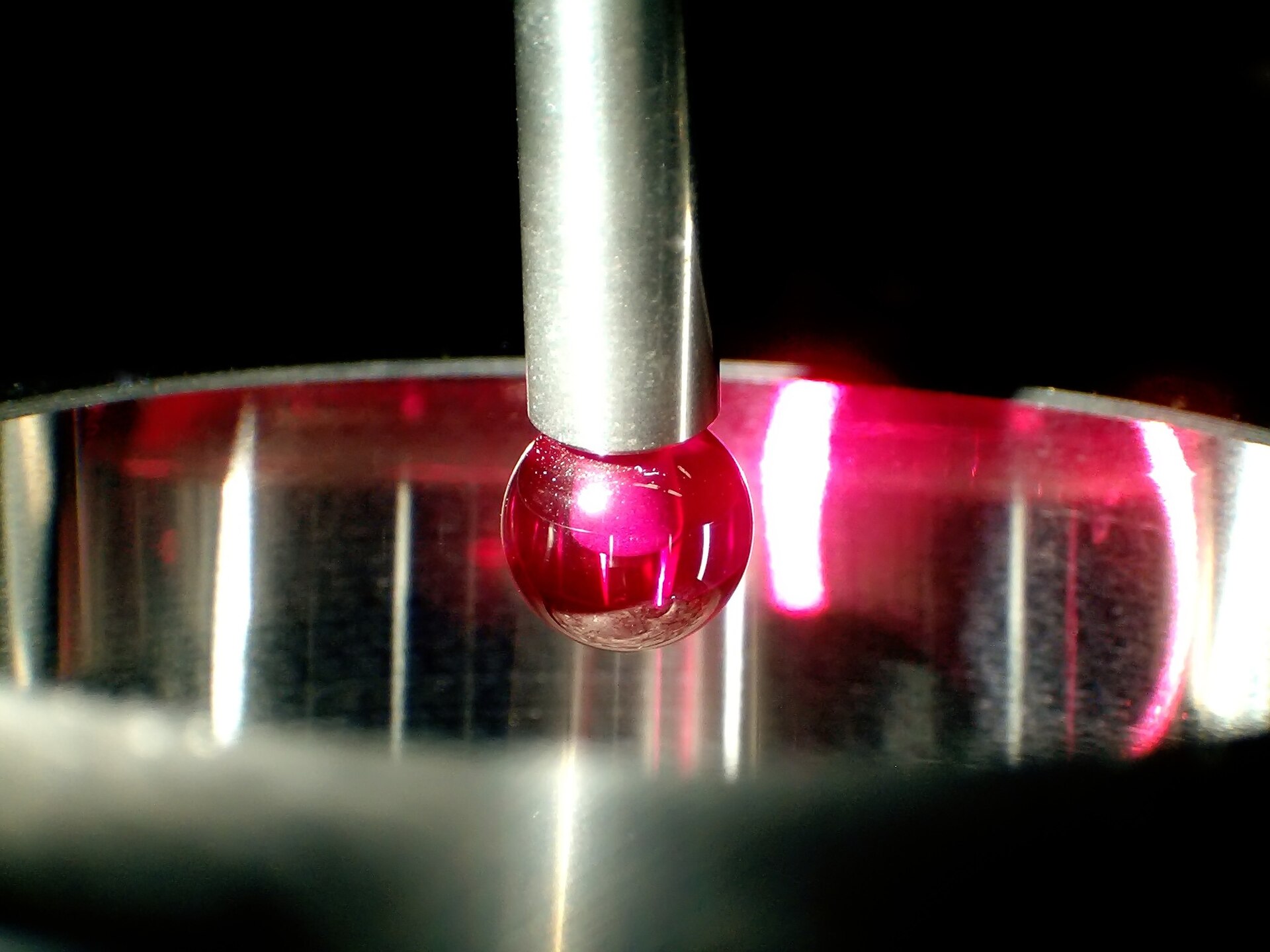 Ruby-tipped CMM touch probe stylus contacting a machined metal bore. Photo by Rally, Wikimedia Commons.