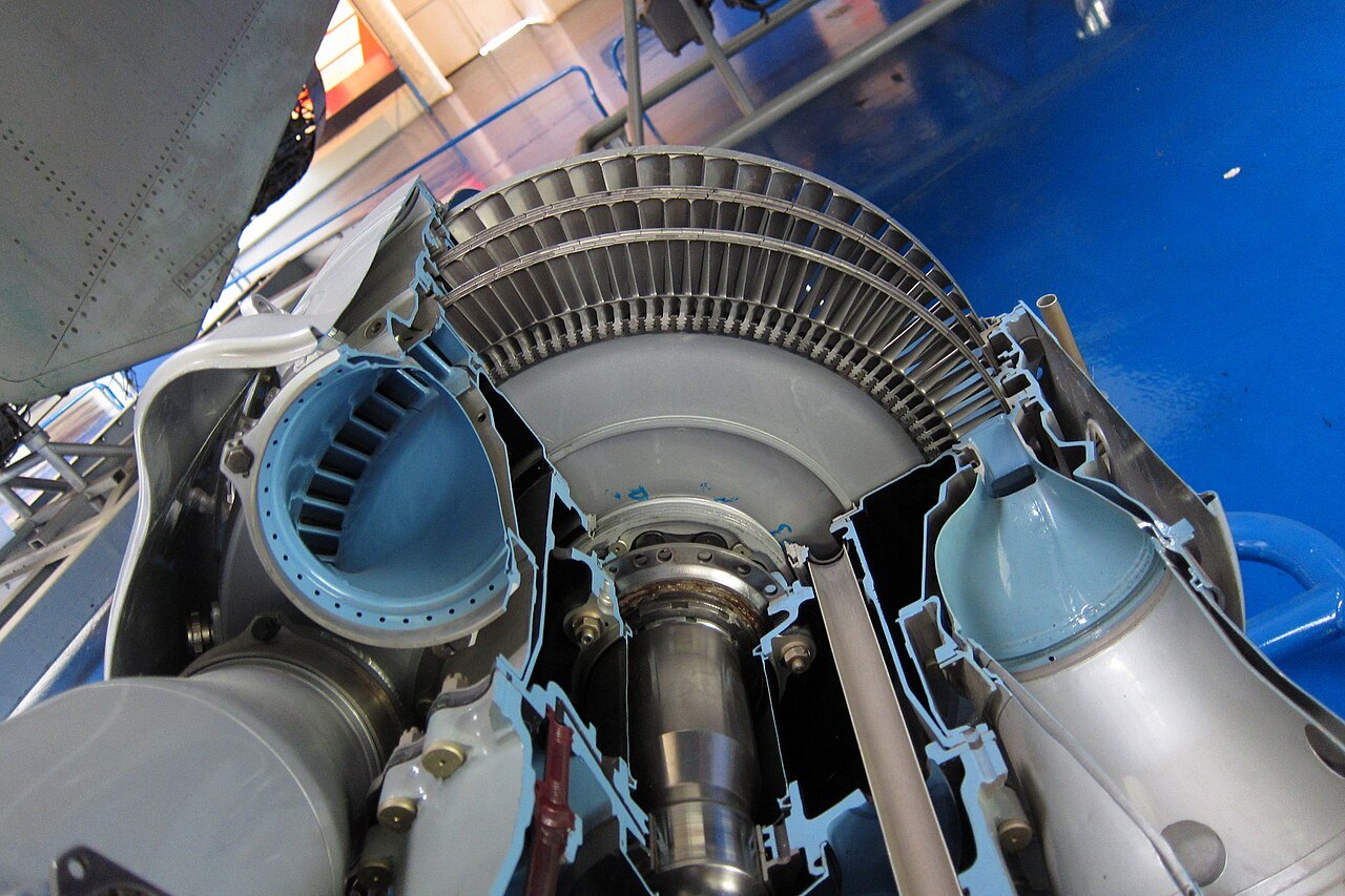 A sectioned Rolls-Royce Dart turboprop engine on display, showing the turbine disc and blades behind a cutaway casing.